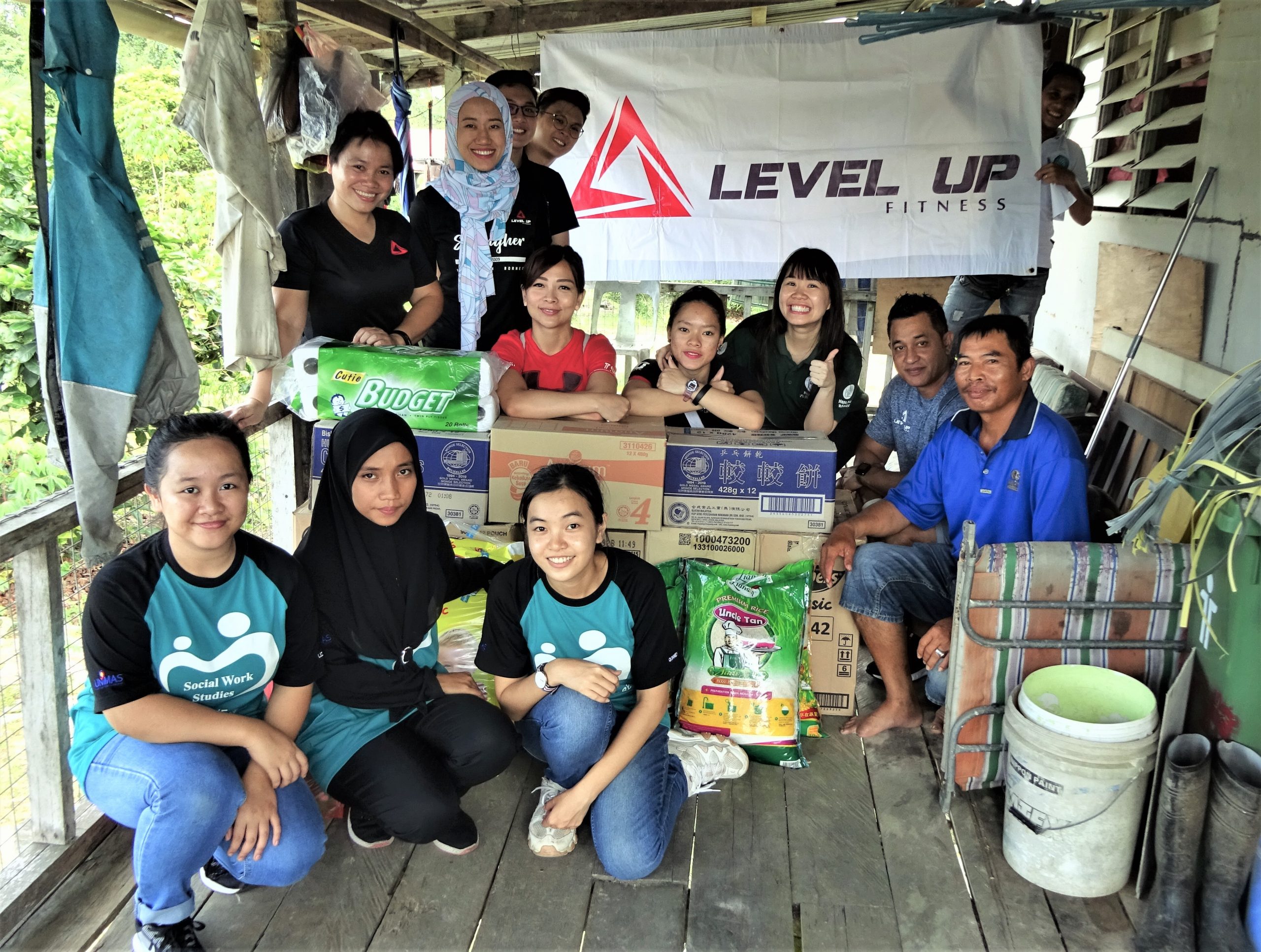 Staff of Level Up Fitness and Hope Place with their contribution of food ration to a family.