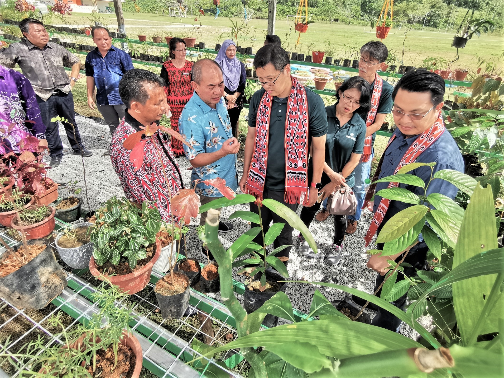 Tan is being briefed by Rentap (second left) on the 'Sustainability Gallery'.