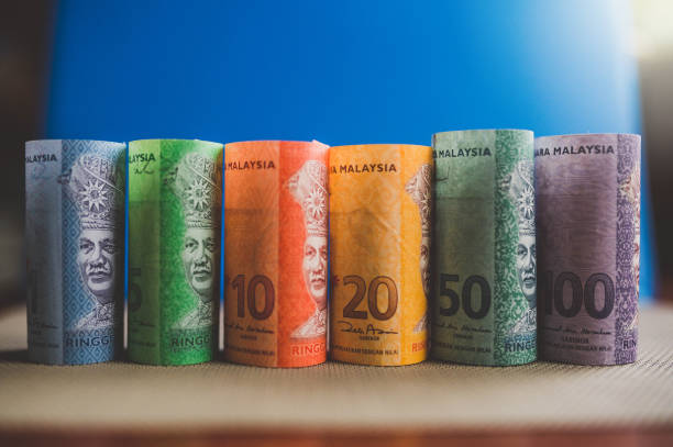 Image of Malaysian ringgit banknotes on blue background