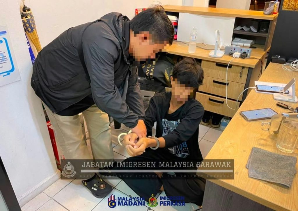 Immigration personnel detain foreigners during the operations.